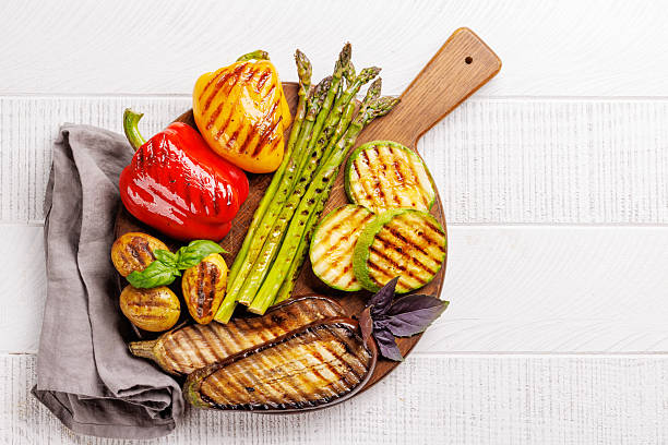 istock Assorted grilled vegetables including bell peppers, zucchini, eggplant, and asparagus 2220221568