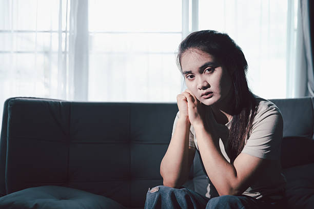 istock Sorrowful woman sat alone, overwhelmed by emotion, her sad and unhappy expression revealing deep despair, stress and distress left feeling depressed. sorrowful sad, despair alone, depressed stress 2220222716