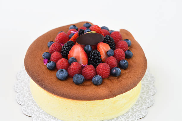 Fluffy Japanese Cheesecake topped with strawberries, raspberries, blueberries, and blackberries closeup side view of delightful and popular dessert
