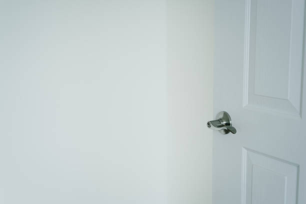 istock White Wall with Open Door and Modern Door Handle in Minimalist Interior Setting 2220226006