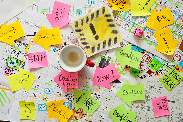 istock Calendars with business appointments, deadline notice and adhesive notes on cluttered desk. Business concept,beat the clock,stress,overwoked,bureaucracy 2220231047