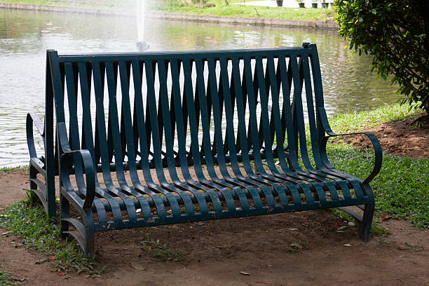 Old bench in the park sidewalk, stock photo