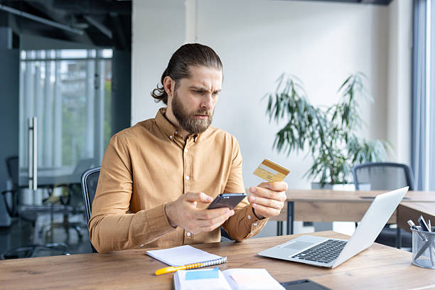 istock Man using smartphone and credit card for online financial transaction 2220233702