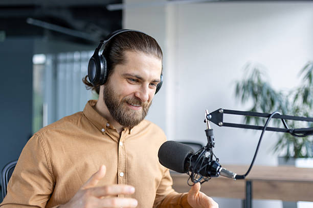 istock Podcaster Recording Audio with Headphones in a Professional Office Setting 2220233720