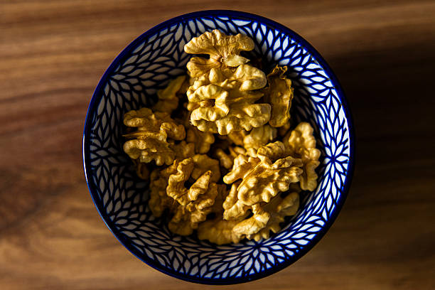 Top view of fresh walnuts in a ceramic bowl