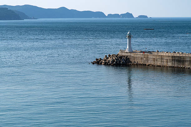 istock lighthouse on the seawall at the harbor 2220238994