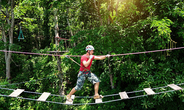 istock A man is walking across a challenging ropes course in the extreme park 2220241248