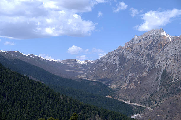 Landscape view in Huanglong, a scenic and historic interest area in the northwest part of Sichuan, China. It is located in the southern part of the Minshan mountain range. Huanglong was declared a World Heritage Site by UNESCO in 1992 because of its outstanding travertine formations, waterfalls and limestone formations as well as its travertine terraces and lakes rating among the three most outstanding examples in the world.