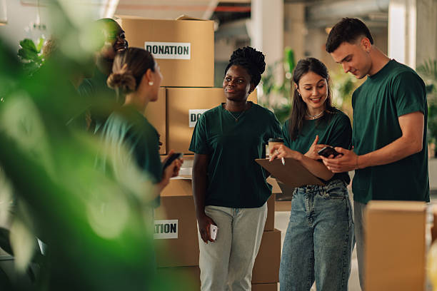 istock Volunteers keeping track of donations in cardboard boxes 2220243063