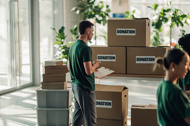 istock Volunteers preparing donation boxes at charity organization 2220243150
