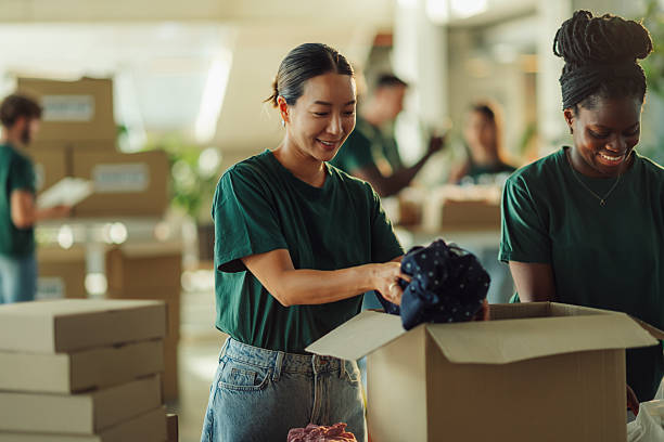 istock Volunteers preparing clothes donations for charity in cardboard boxes 2220243189