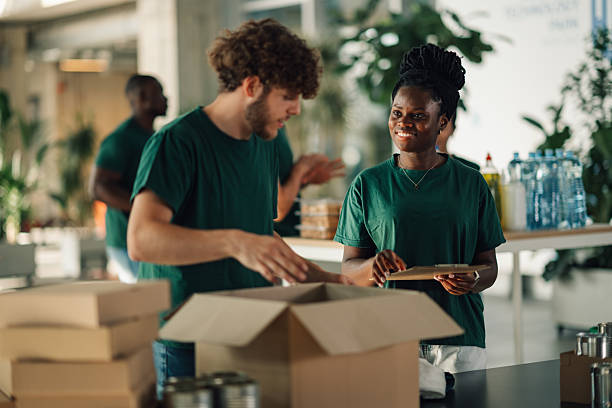 istock Volunteers preparing donation boxes at charitable organization 2220243225