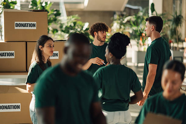 istock Volunteers organizing donation boxes in a community center 2220243248