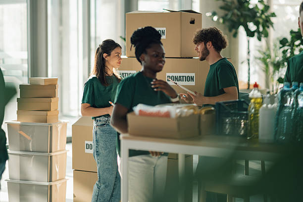 istock Volunteers preparing donation boxes at charity organization 2220243251