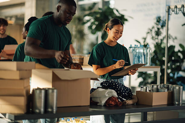 istock Volunteers preparing donation boxes at charity organization 2220243262