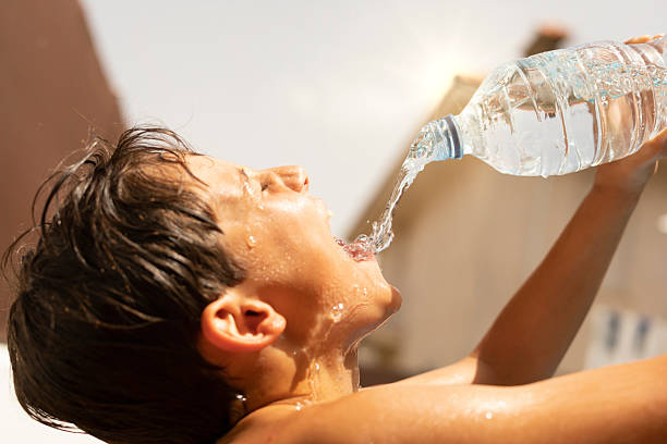istock Drinking bottled water due to heat stroke in a summer heat wave 2220243742