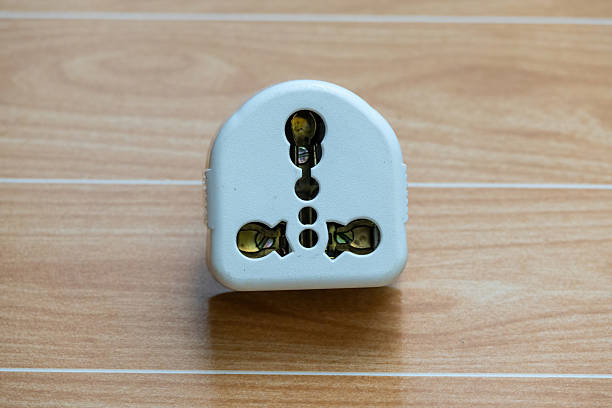 istock Close up of an old white three pin electrical socket on a wooden surface. 2220244294