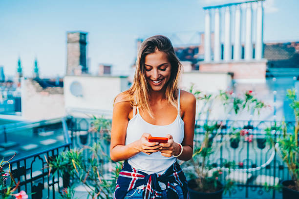istock Summer rooftop relaxation with smartphone in the city 2220245102