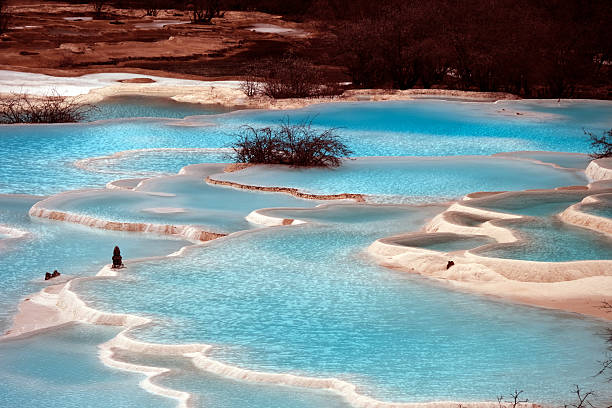 View of the Multi-Colored Pond in Huanglong, a World Heritage Site by UNESCO in 1992 because of its outstanding travertine formations, waterfalls and limestone formations as well as its travertine terraces and lakes rating among the three most outstanding examples in the world. Sichuan, China.