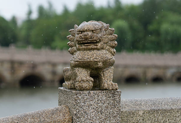 istock Stone lions on the ancient bridge in the rain 2220247438