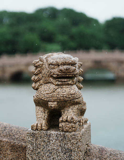 istock Stone lions on the ancient bridge in the rain 2220247442