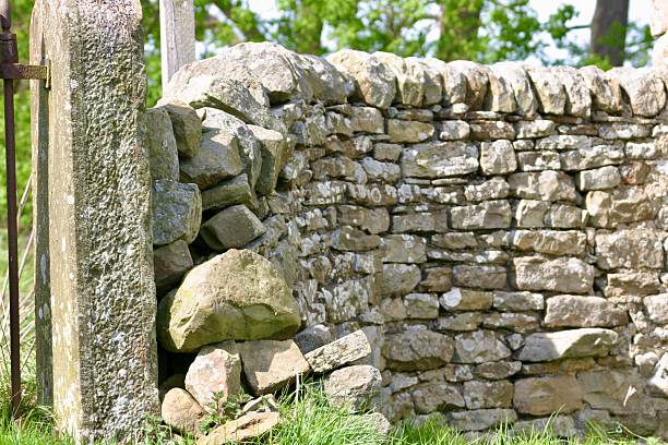 istock Close up of a dry stone wall with a stone post 2220248032