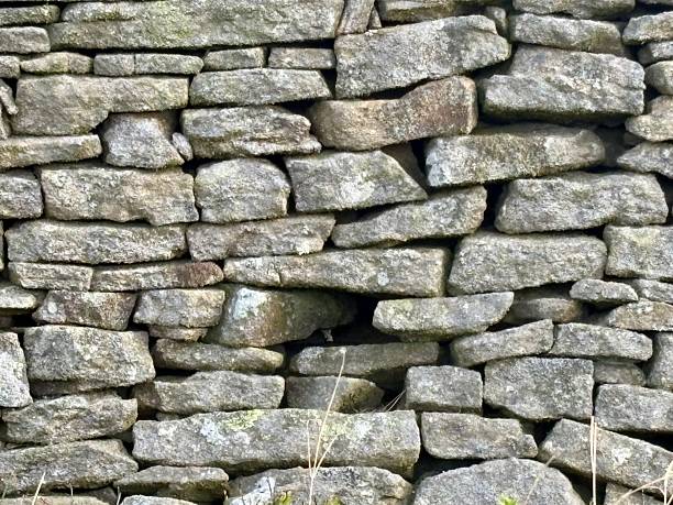 istock Close up of a dry stone wall with a stone missing 2220248098
