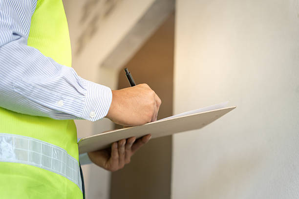 istock inspector or engineer is inspecting construction and quality assurance new house using a checklist. Engineers or architects or contactor work to build the house before handing it over to the homeowner 2220255095