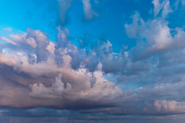Serene sunset scenery featuring a vibrant mixture of colorful clouds and a vivid sky, evoking calm and tranquility, suitable as a background for peaceful designs or tranquil imagery.
