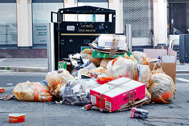 White Trash Garbage Bags All Over Closed Footpath Street in London at Night