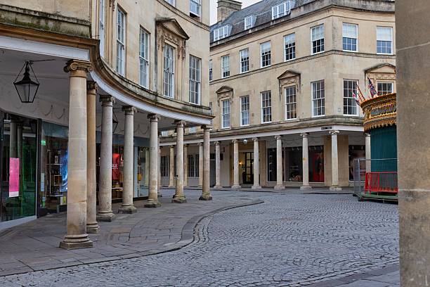 istock A curved, colonnaded walkway leads to a classic building with arched windows. 2220266607
