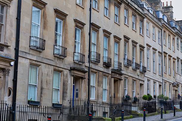 istock A row of uniform, classically designed townhouses 2220266866