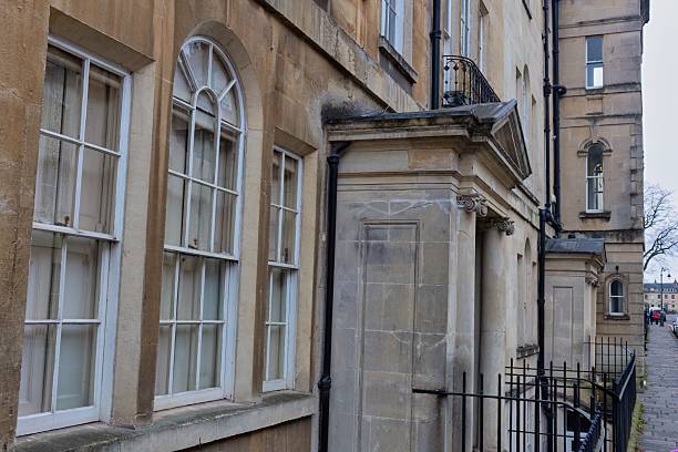 istock A blurred view of a building facade with arched windows and a stone porch. 2220266941