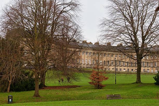 istock A park with bare trees in the foreground and a large building 2220267001