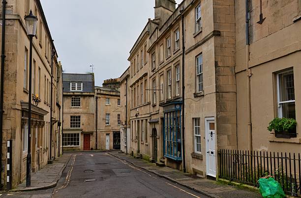 istock A quiet street is lined with tall, beige buildings. 2220267094