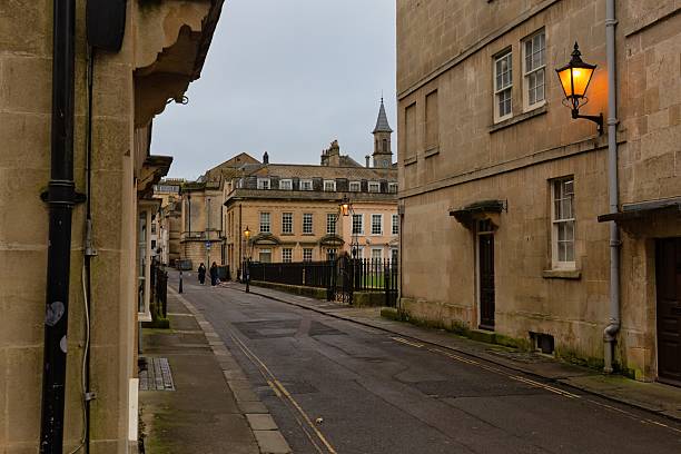 istock A quiet street lined with sandstone buildings under a cloudy sky. 2220267116