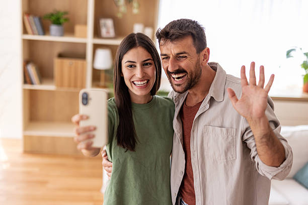 istock Happy couple making a video call from home using smartphone 2220267178