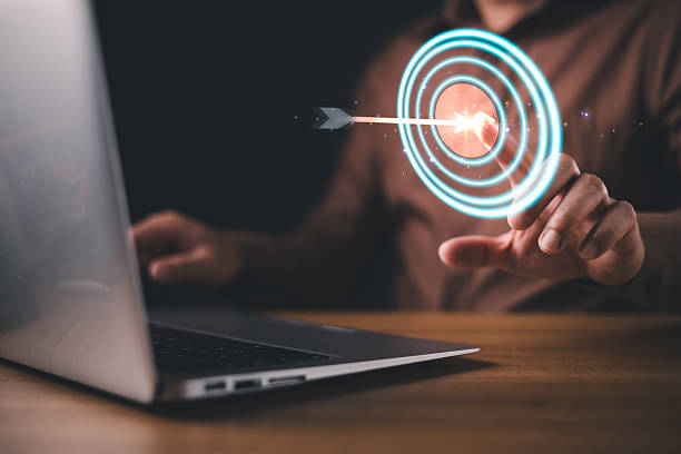 istock A person interacts with a futuristic digital target interface, symbolizing business goals, precision, success, strategy, and focus, with a glowing arrow hitting the center of a virtual bullseye. 2220269420