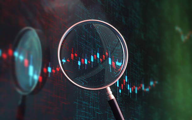 istock Finance Business and Financial and Technical Data Table and Analysis with Magnifier in Background 2220272858