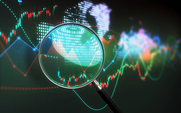 istock Finance Business and Financial and Technical Data Table and Analysis with Magnifier in Background 2220272872