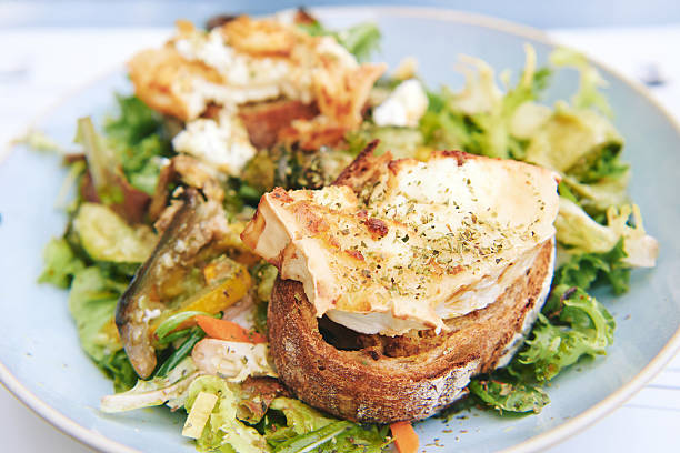 Lettuce salad with cherry tomatoes, California walnuts and raisins with fried goat cheese