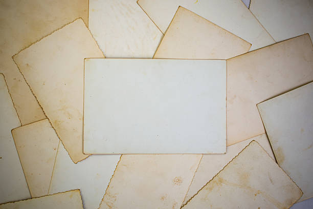 Old photography paper stained and stacked, empty textured backdrop