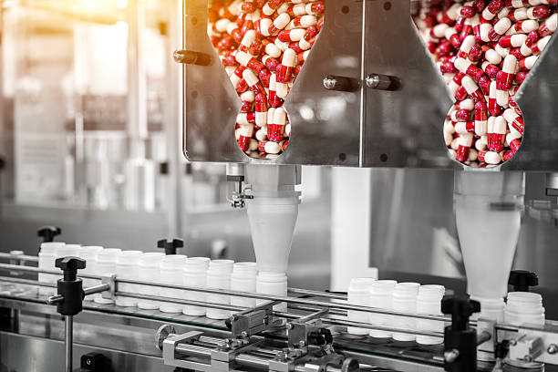istock Tablet, Capsule counting machine conveyor in production line of pharmaceutical industry. 2220280129
