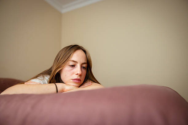 istock Young woman is resting on bed in bedroom. 2220280457
