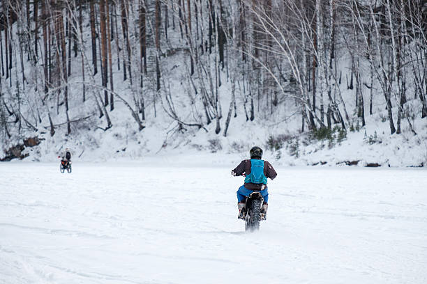 istock A man is riding a motorcycle in the snow 2220280577