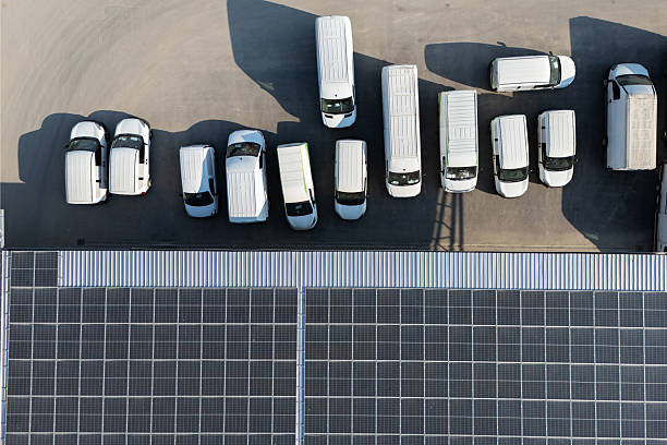 istock Delivery vans hub with solar panel on a roof. Fleet of vehicles 2220283048