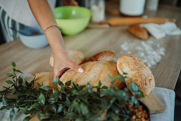 istock Young caucasian woman making bread dough in her kitchen 2220285460