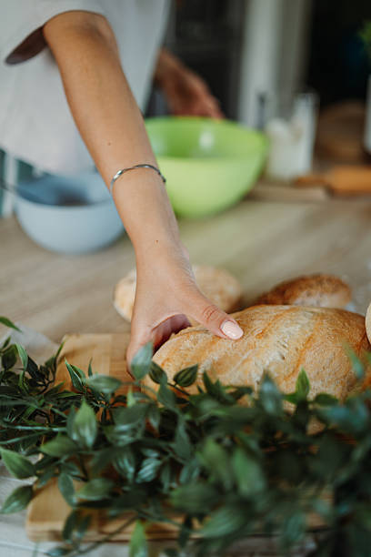 istock Young caucasian woman making bread dough in her kitchen 2220285464