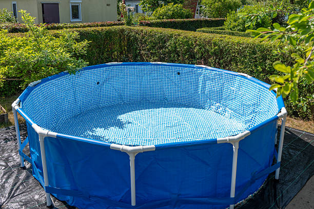 istock Empty above-ground pool set up in the garden, ready to be filled. 2220285617