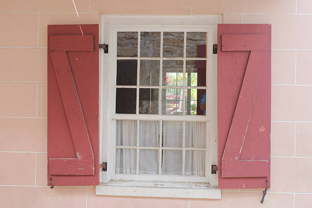 Rustic Window With Red Wooden Shutters and White-Paned Design